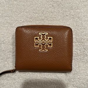 Tory Burch brown pebbled leather folded wallet.